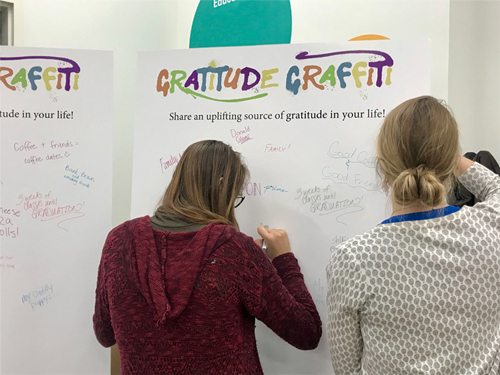 Students filling in a Gratitude Graffiti Tri-Fold