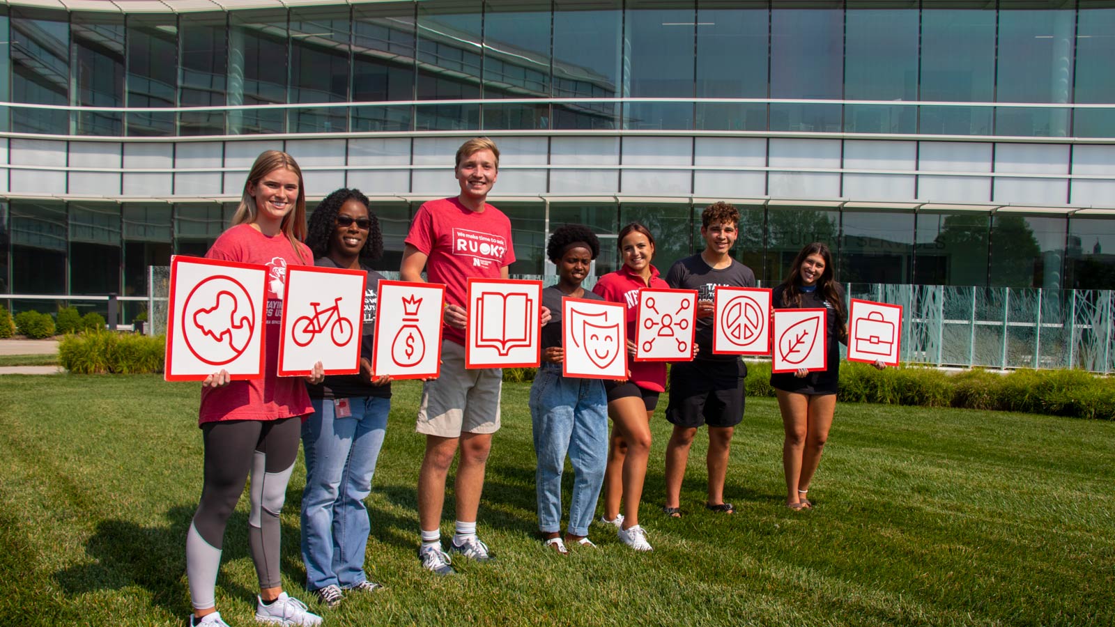 Students hold dimensions of well-being icons