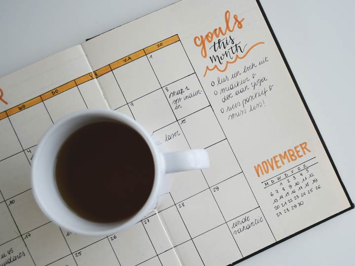Calendar and cup of coffee