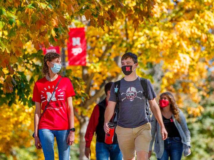 Students talking as walking across campus