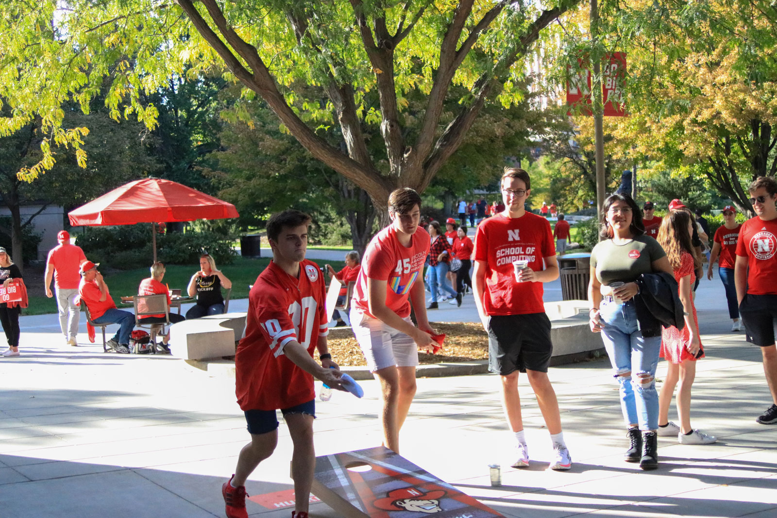 Students play cornhole at Sober Tailgate event